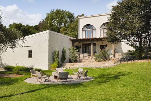 rear view of house with outdoor lounge area, a yard, and a patio