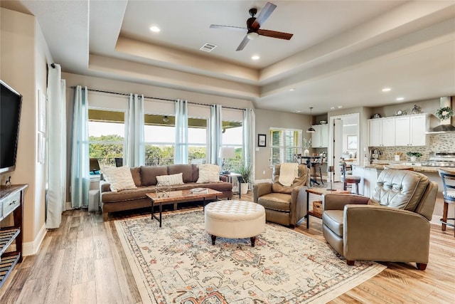 3500 Lohmans Ford Rd Unit 71, Lago Vista, TX 78645 - living room with a raised ceiling, a ceiling fan, light wood-type flooring, recessed lighting, and baseboards