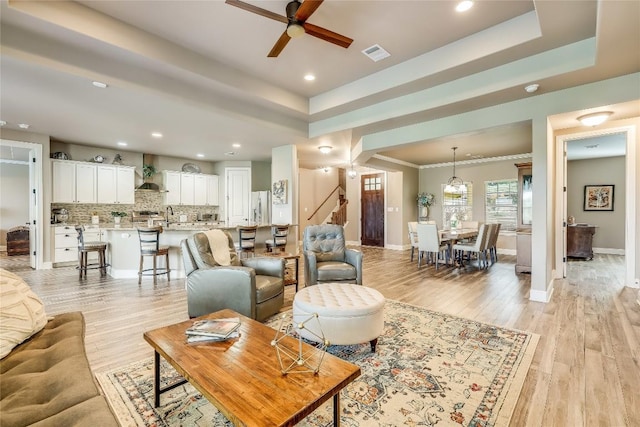 3500 Lohmans Ford Rd Unit 71, Lago Vista, TX 78645 - living room featuring stairway, a raised ceiling, ceiling fan, recessed lighting, and light wood finished floors