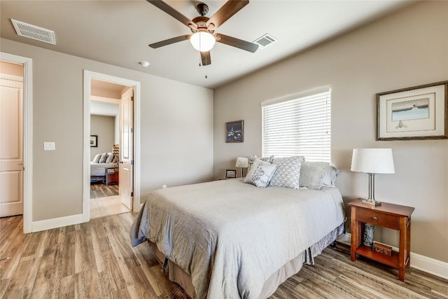 bedroom featuring light hardwood / wood-style flooring and ceiling fan