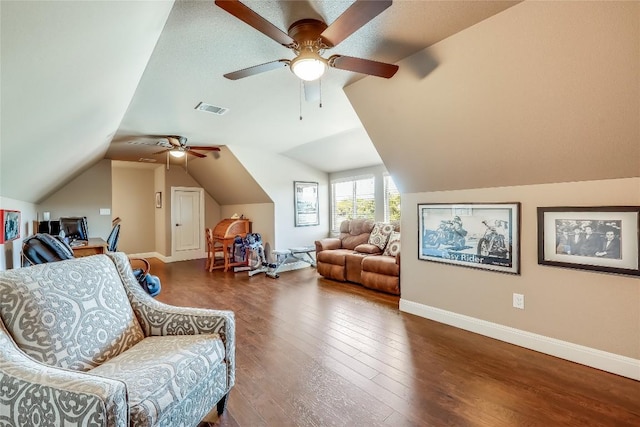 living area featuring ceiling fan, dark hardwood / wood-style flooring, lofted ceiling, and a textured ceiling