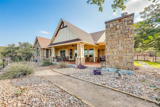 3500 Lohmans Ford Rd Unit 71, Lago Vista, TX 78645 - back of house with board and batten siding, stone siding, a ceiling fan, and a shingled roof