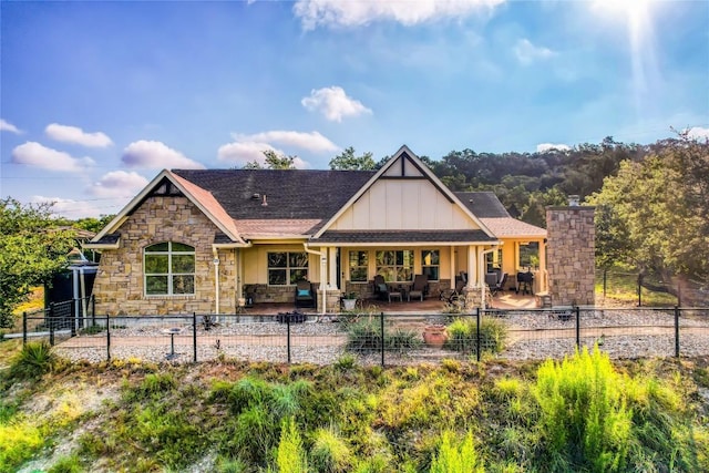 3500 Lohmans Ford Rd Unit 71, Lago Vista, TX 78645 - back of property with stone siding, a porch, board and batten siding, and a fenced front yard