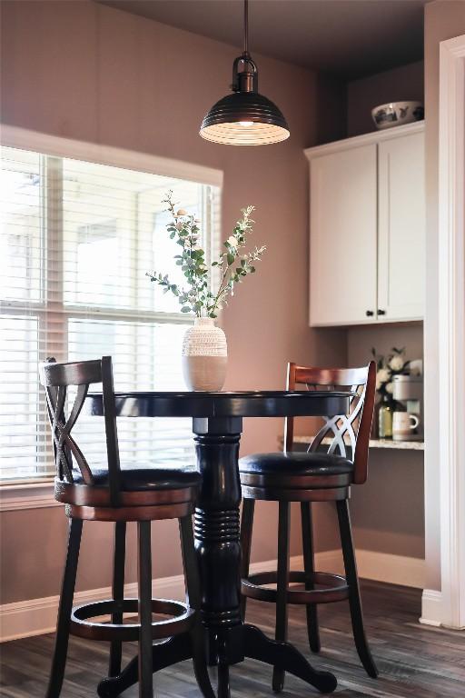 dining space with dark wood-type flooring