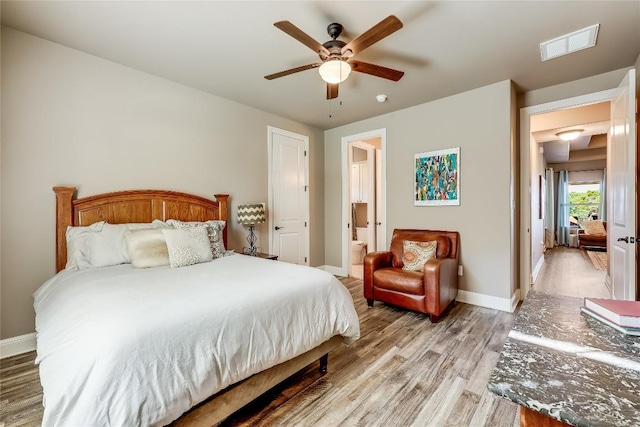 3500 Lohmans Ford Rd Unit 71, Lago Vista, TX 78645 - bedroom with light wood-type flooring, ensuite bath, and a ceiling fan