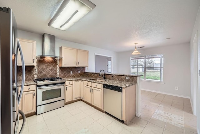 kitchen with wall chimney range hood, sink, appliances with stainless steel finishes, light tile patterned flooring, and kitchen peninsula