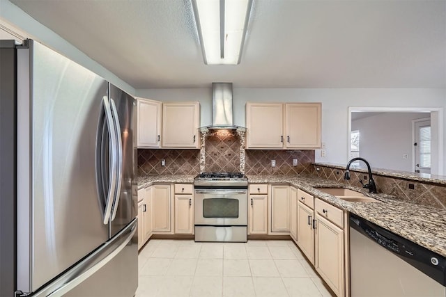 kitchen featuring decorative backsplash, wall chimney exhaust hood, stainless steel appliances, sink, and dark stone countertops