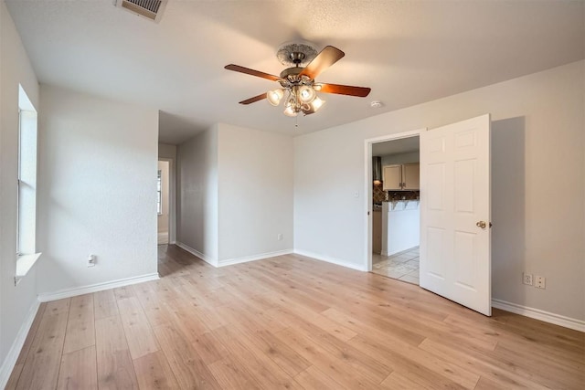 spare room with ceiling fan and light hardwood / wood-style flooring