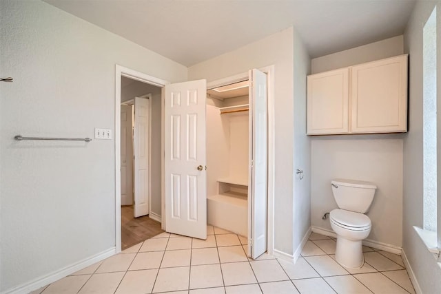 bathroom featuring toilet and tile patterned floors