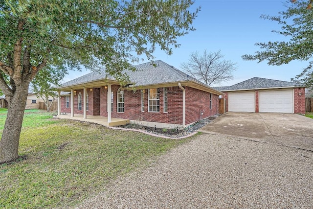 view of front of home with a porch, a garage, and a front lawn