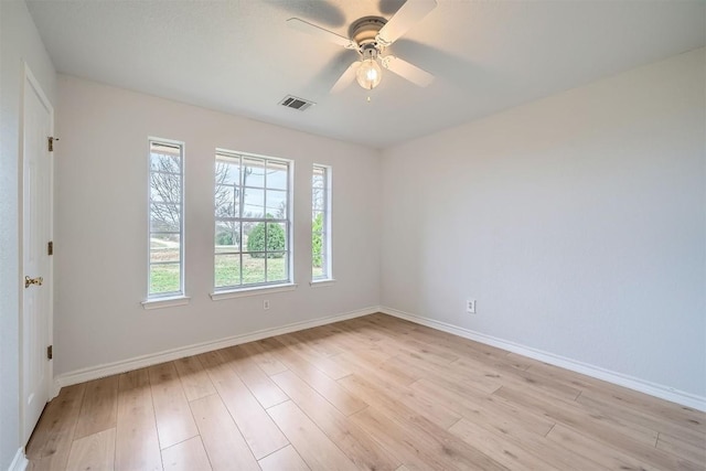 empty room with light wood-type flooring, plenty of natural light, and ceiling fan