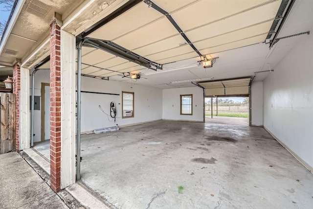 garage with electric panel and a garage door opener