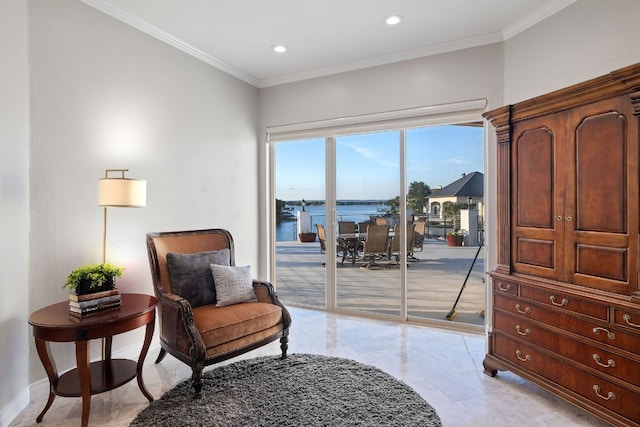 living area with a water view and crown molding