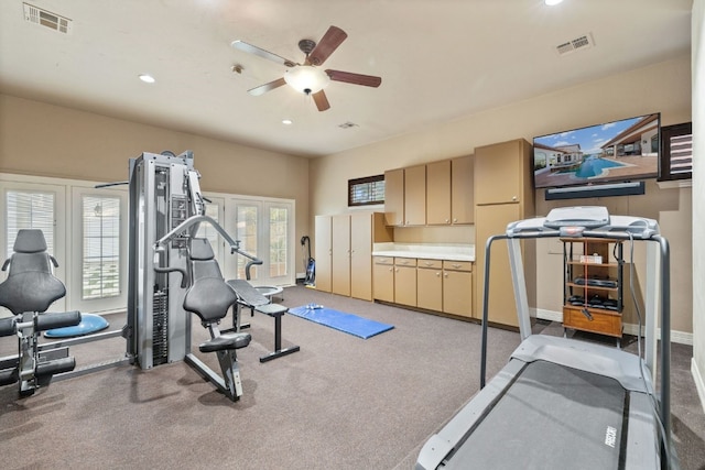 exercise area with carpet flooring, ceiling fan, and french doors