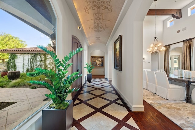 corridor with an inviting chandelier