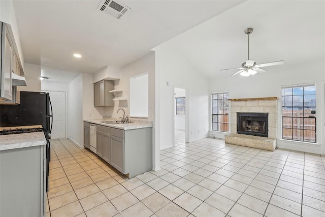 kitchen featuring black fridge, gray cabinetry, ceiling fan, sink, and light tile patterned floors