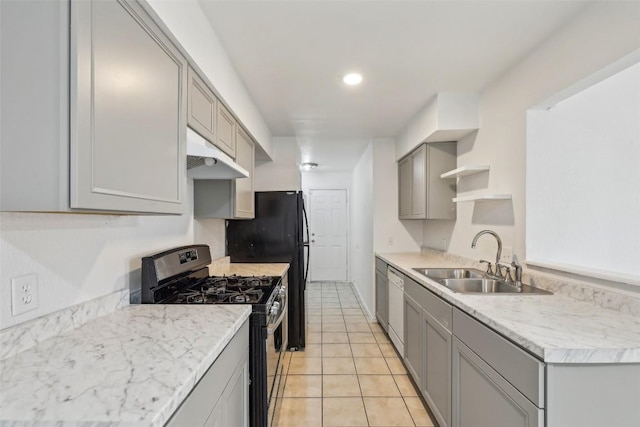 kitchen featuring dishwasher, sink, gray cabinets, light tile patterned floors, and gas stove