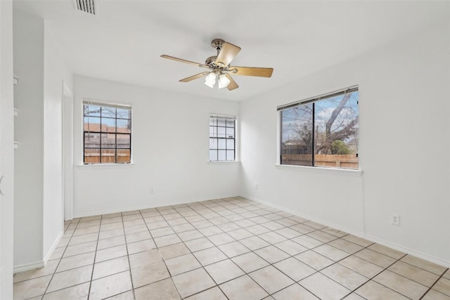 tiled empty room with ceiling fan