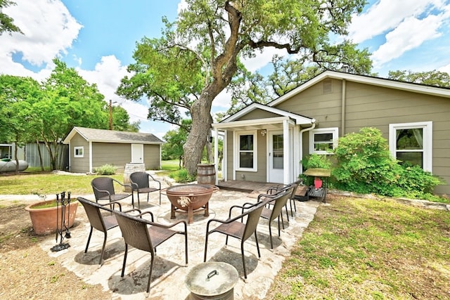 view of patio featuring a fire pit and an outdoor structure