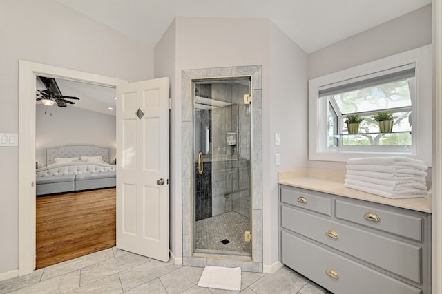 bathroom featuring tile patterned floors, ceiling fan, lofted ceiling, and a shower with door