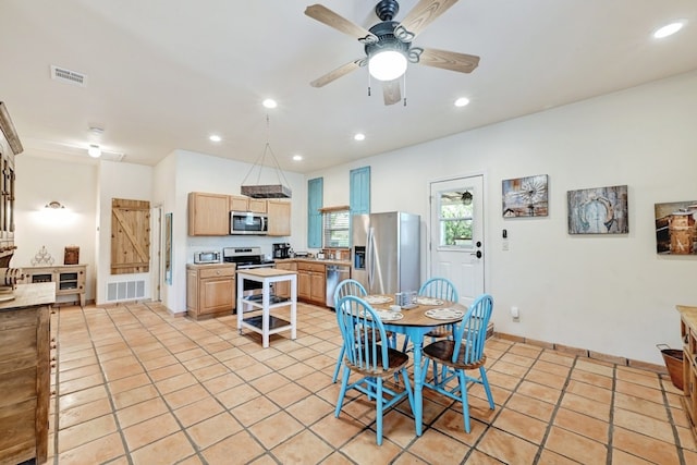 dining space featuring ceiling fan and light tile patterned flooring