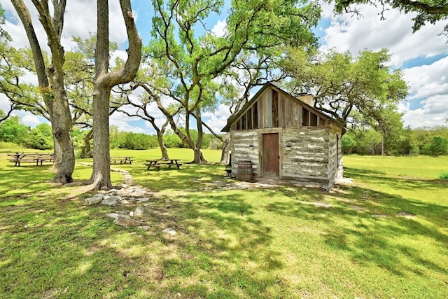 view of outdoor structure featuring a lawn