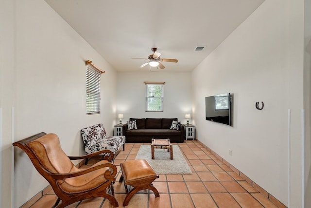 living room with ceiling fan and light tile patterned flooring