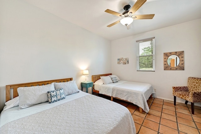 tiled bedroom featuring ceiling fan