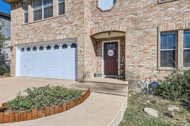 doorway to property with a garage