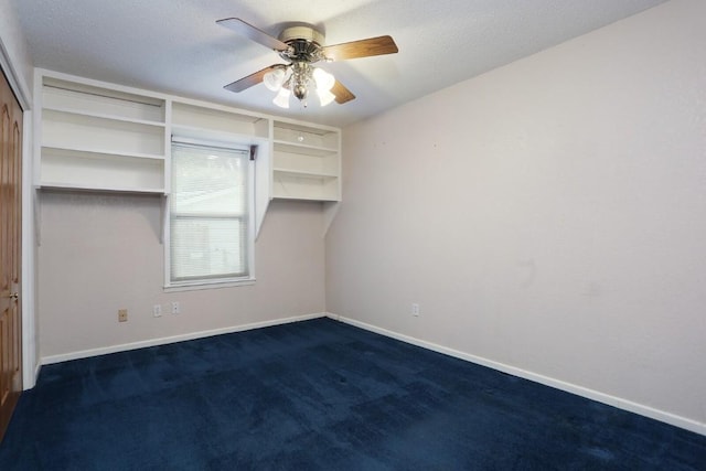 unfurnished bedroom featuring ceiling fan, a closet, a textured ceiling, and dark colored carpet