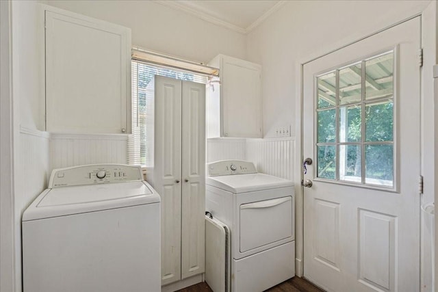 laundry area featuring cabinets, separate washer and dryer, ornamental molding, and dark wood-type flooring