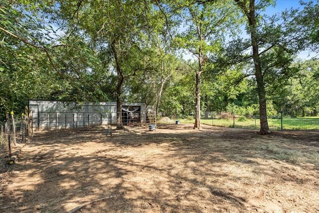 371 Youngs Prairie Rd, Elgin, TX 78621 - view of yard featuring an outdoor structure and view of wooded area