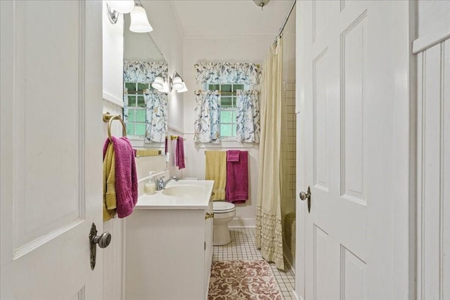 bathroom featuring tile patterned flooring, vanity, and toilet