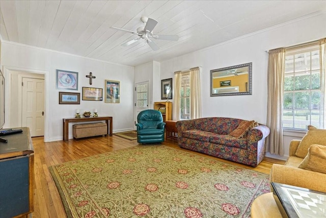 living room featuring ceiling fan, a healthy amount of sunlight, wood-type flooring, and wood ceiling