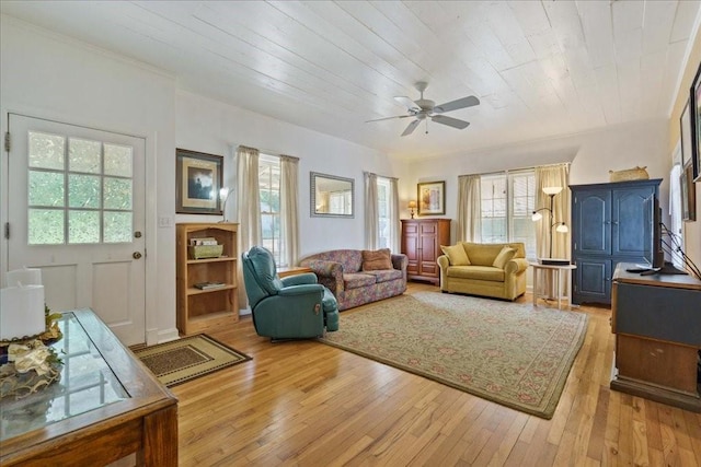 371 Youngs Prairie Rd, Elgin, TX 78621 - living room featuring a ceiling fan, plenty of natural light, light wood-style flooring, ornamental molding, and wooden ceiling