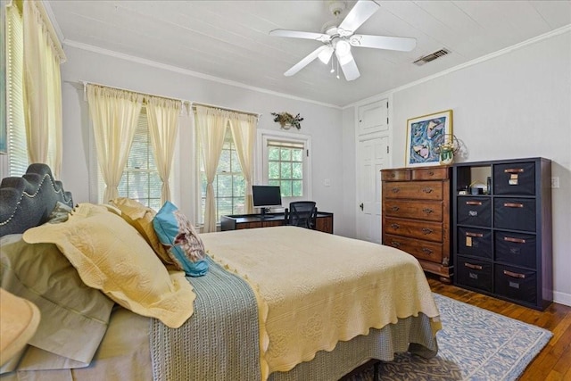 371 Youngs Prairie Rd, Elgin, TX 78621 - bedroom with dark wood-type flooring, crown molding, a ceiling fan, baseboards, and a desk
