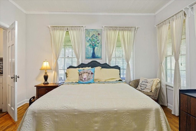 bedroom with wood-type flooring and ornamental molding