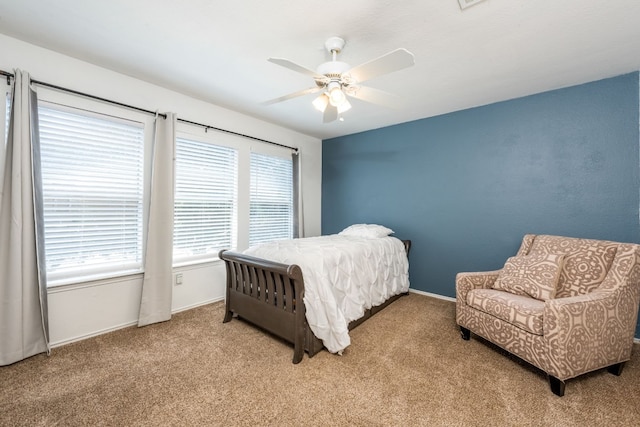 bedroom with ceiling fan and light carpet