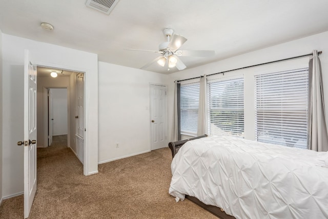 bedroom featuring light colored carpet and ceiling fan