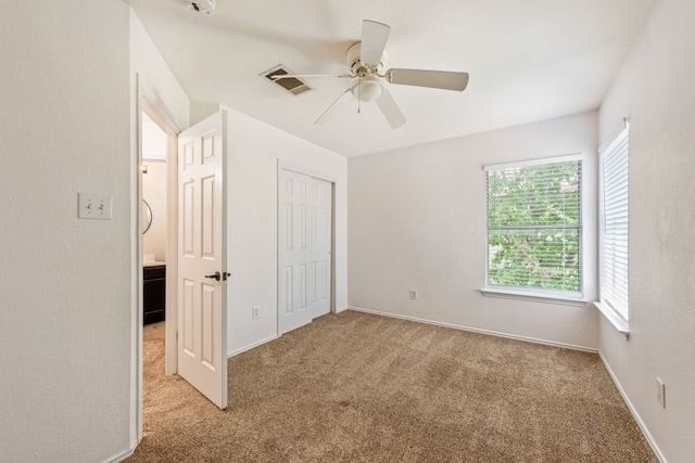 unfurnished bedroom with ceiling fan and light colored carpet