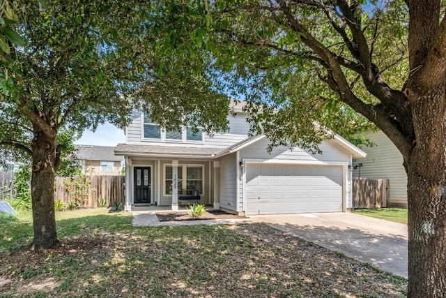 view of property with covered porch and a garage