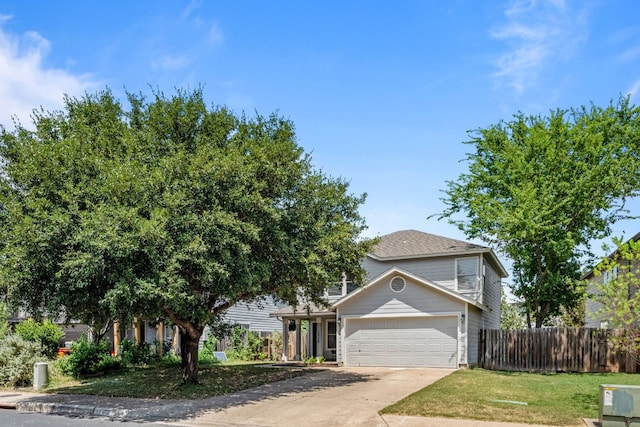 obstructed view of property featuring a garage and a front lawn