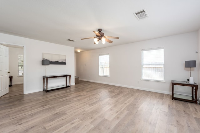 unfurnished living room featuring ceiling fan and light hardwood / wood-style floors