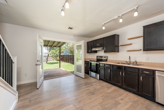 kitchen with light hardwood / wood-style floors, sink, and stainless steel appliances