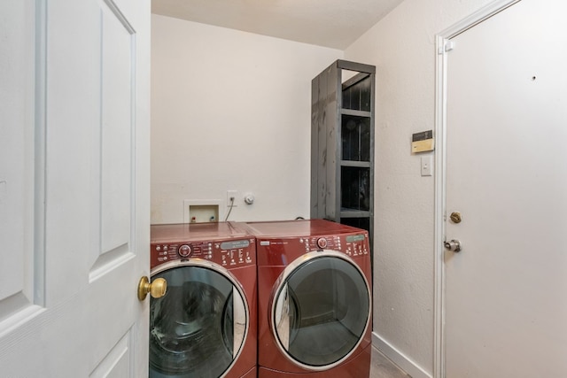 clothes washing area featuring separate washer and dryer