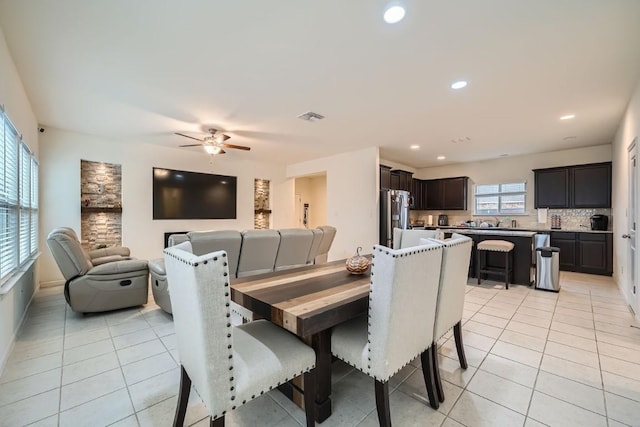 dining area featuring ceiling fan and light tile patterned floors