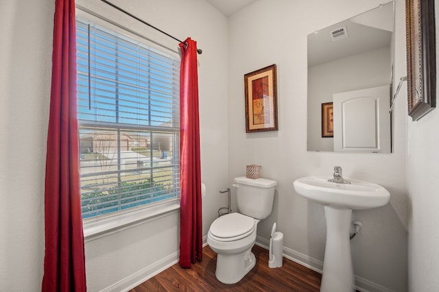 bathroom featuring wood-type flooring and toilet