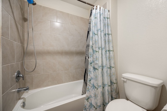 bathroom with shower / bath combo with shower curtain and toilet