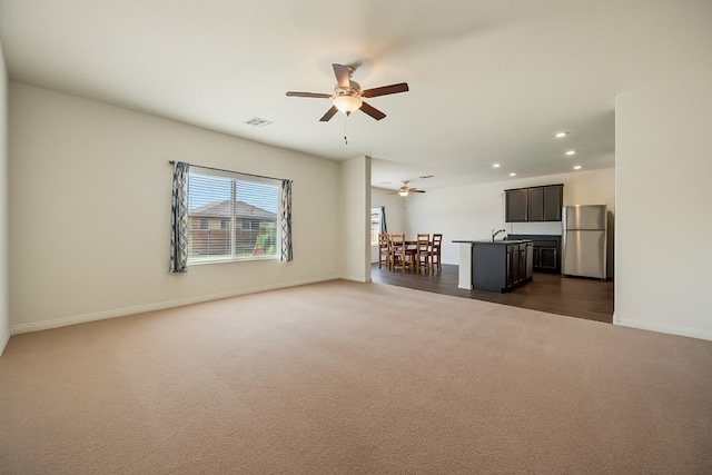 14405 Boomtown Way, Elgin, TX 78621 - unfurnished living room featuring dark carpet, a ceiling fan, and recessed lighting