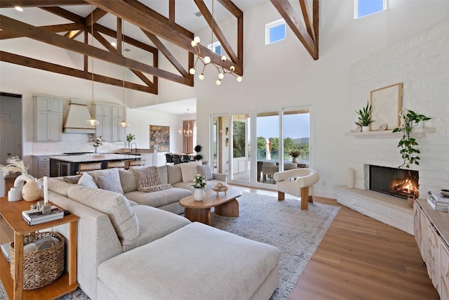 living room with beam ceiling, a fireplace, high vaulted ceiling, and hardwood / wood-style floors